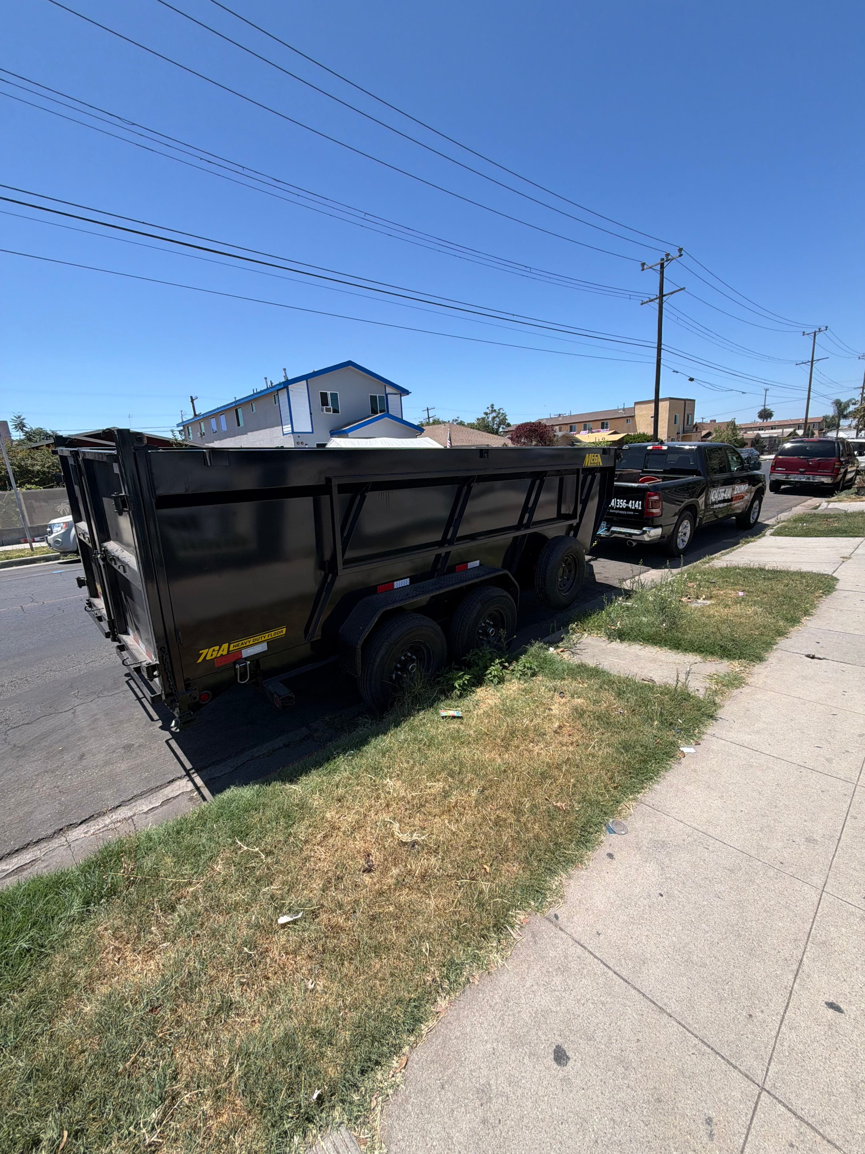 Dump Happy truck and dump trailer parked on a Los Angeles residential street for a junk removal job