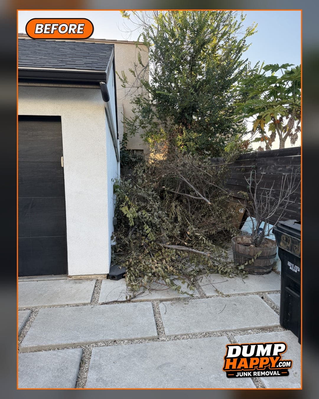 Overgrown tree branches and yard debris piled against a house before a Dump Happy yard waste clean-out